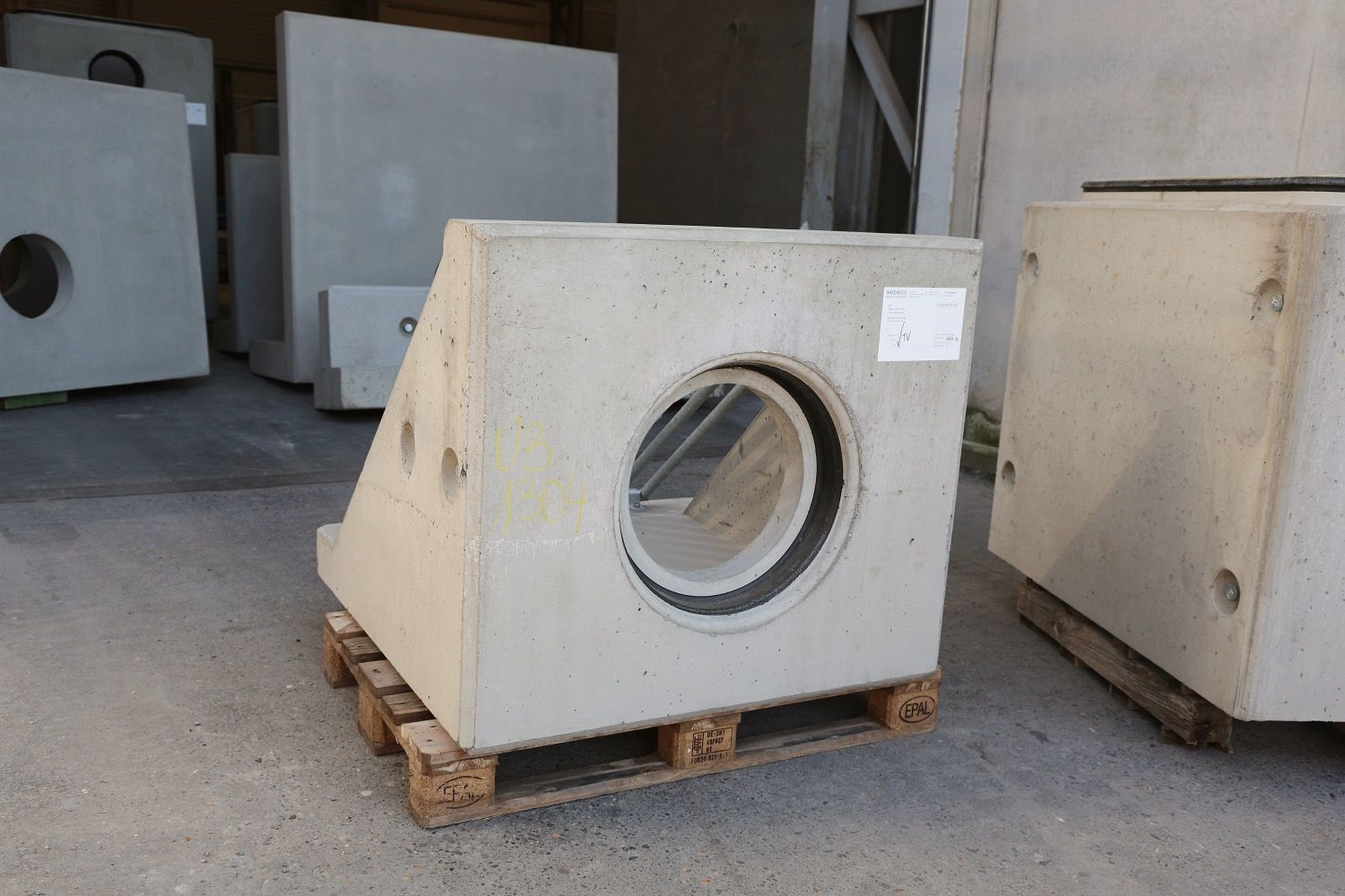 A stack of precast concrete pipes at Webeco, ready for use in sustainable water infrastructure projects.